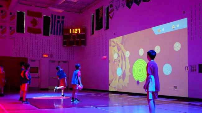kids using projector for basketball game