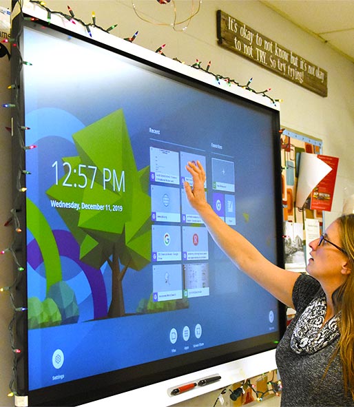 teacher using interactive display